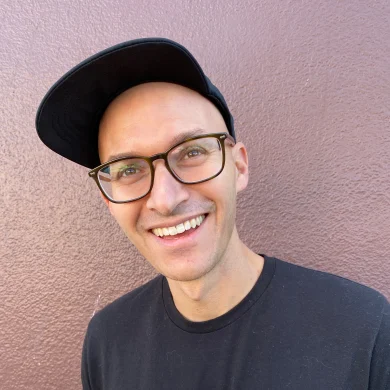 Ramp smiling wearing glasses and a black cap