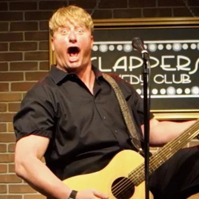 Gig Entertainer Ramp performing with a guitar at Flappers Comedy Club